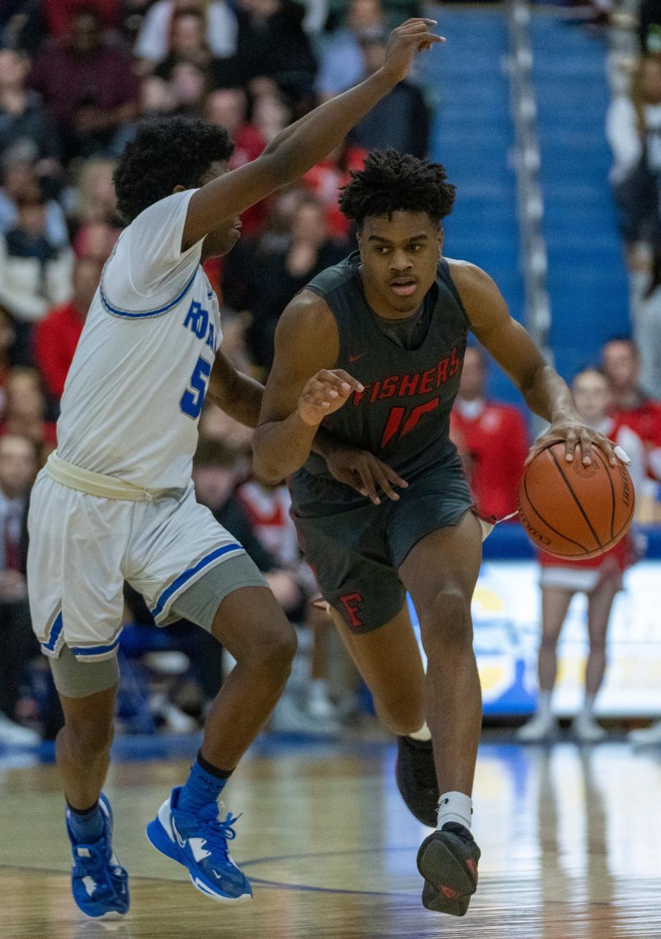 Fishers High School's guard Jalen Haralson (10) is defended by Hamilton Southeastern High School's guard Deion Miles (5) at Carmel High School, Tuesday, Feb. 28, 2023, during the Fishers boys’ sectional win over HSE, 68-49. 