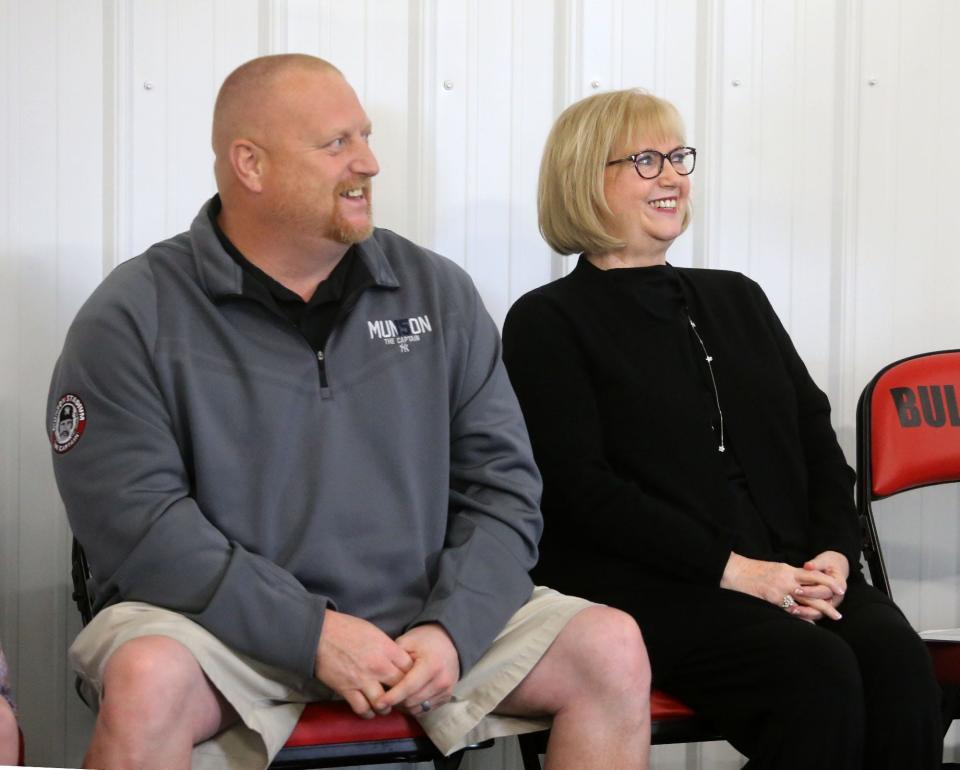 Mike and Diana Munson, the son and widow of the late Thurman Munson, listen during the rededication of Thurman Munson Memorial Stadium in Canton on Saturday.