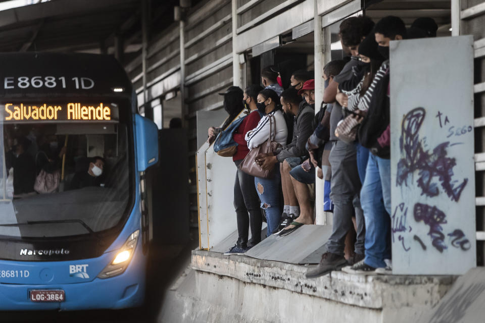 Commuters wait for a public Rapid Transit Bus (BRT) during the COVID-19 pandemic in Rio de Janeiro, Brazil, Friday, July 23, 2021, during the COVID-19 pandemic. (AP Photo/Bruna Prado)