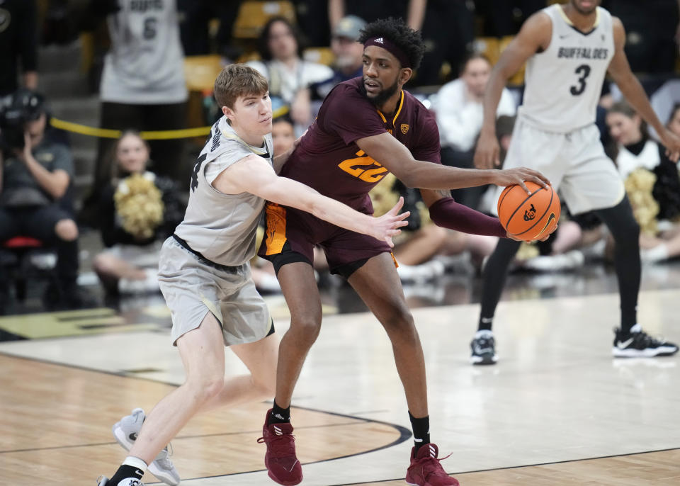 Arizona State forward Warren Washington, front right, passes the ball as Colorado center Lawson Lovering, left, defends in the second half of an NCAA college basketball game Thursday, Dec. 1, 2022, in Boulder, Colo. (AP Photo/David Zalubowski)