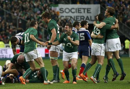 Ireland's players celebrate victory against France at the end of their Six Nations rugby union match at the Stade de France in Saint-Denis, near Paris, March 15, 2014. REUTERS/Benoit Tessier