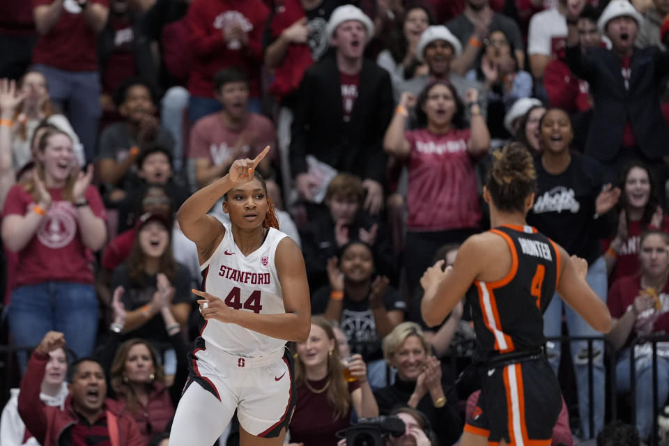 Stanford forward Kiki Iriafen, left, reacts after scoring against Oregon State during the first half of an NCAA college basketball game, Sunday, Jan. 21, 2024, in Stanford, Calif. (AP Photo/Godofredo A. Vásquez)