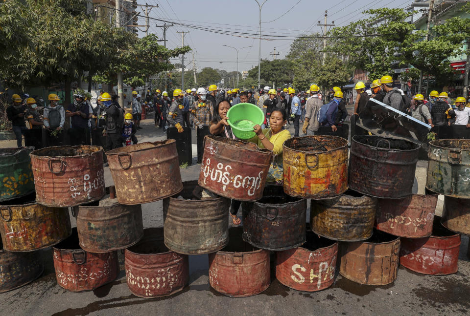 People build barricades to deter security personnel from entering a protest area in Mandalay, Myanmar, Thursday, March 4, 2021. Demonstrators in Myanmar protesting last month's military coup returned to the streets Thursday, undaunted by the killing of at least 38 people the previous day by security forces. (AP Photo)