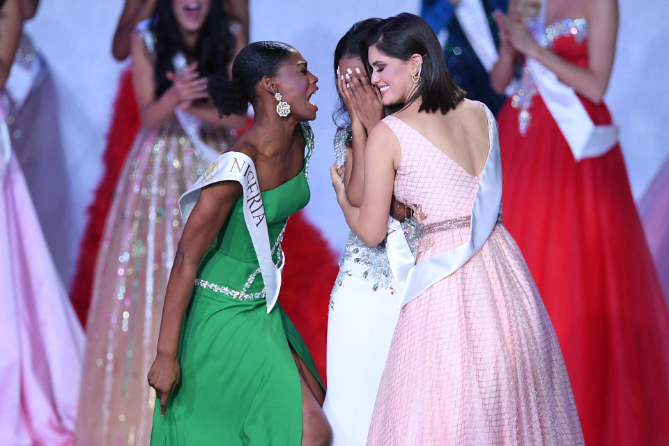 Miss Nigeria Nyekachi Douglas (L) and Miss Brazil Elis Coelho (R) support Miss Jamaica Toni-Ann Singh (C) as she is anounced Miss World 2019 during the the Miss World Final 2019 at the Excel arena in east London on December 14, 2019. (Photo by DANIEL LEAL-OLIVAS / AFP) (Photo by DANIEL LEAL-OLIVAS/AFP via Getty Images)