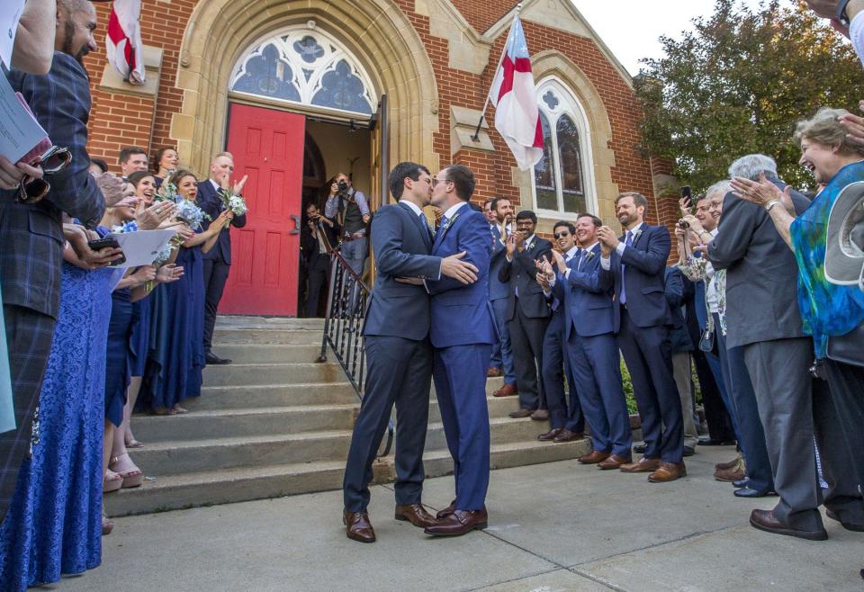 South Bend Mayor Pete Buttigieg, left, kisses Chasten Glezman following their wedding in downtown South Bend. Tribune File Photo