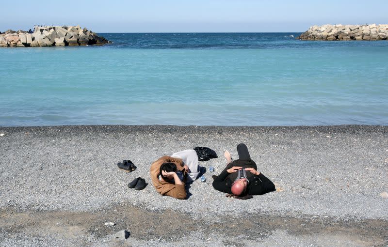 People lay at a beach in Algiers