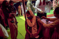 FILE - In this Wednesday, Sept. 29, 2021 file photo, a woman reacts as a health worker inoculates her during a vaccination drive against COVID-19 in New Delhi, India. As coronavirus vaccines trickle into some of the poorest countries in Asia, Africa and the Middle East, data suggest some women are consistently missing out, in another illustration of how the doses are being unevenly distributed around the world. (AP Photo/Altaf Qadri, file)