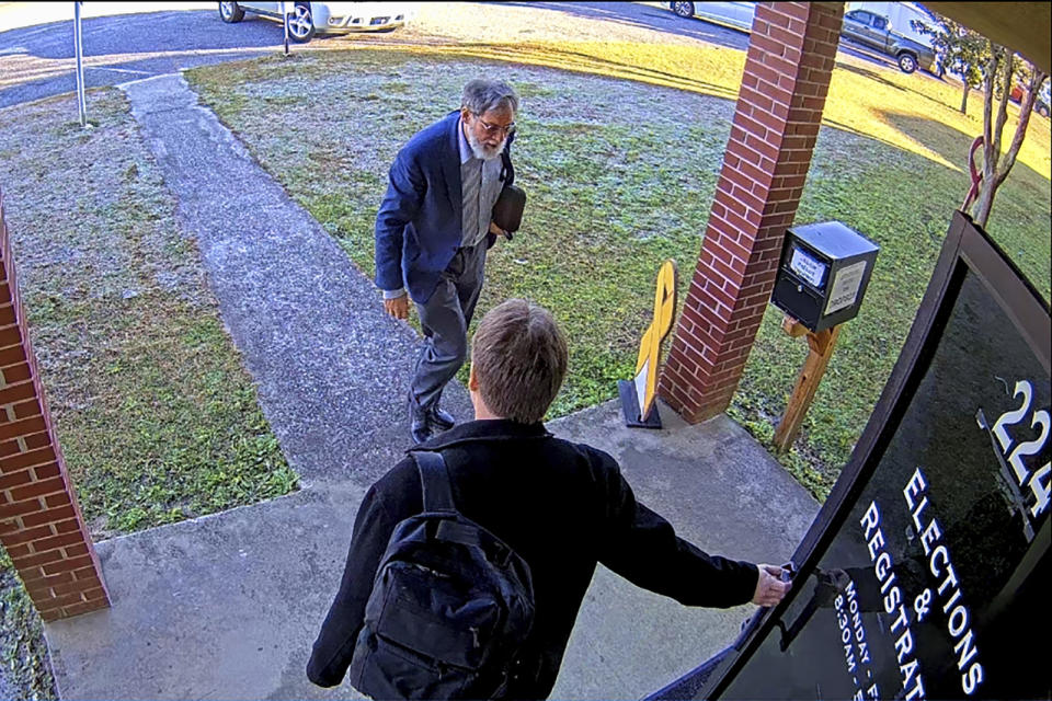 FILE - In this Jan. 19, 2021 image taken from Coffee County, Ga., security video, Doug Logan, bottom, and Jeff Lenberg are seen arriving at the Coffee County elections office in Douglas, Ga. (Coffee County via AP, File)