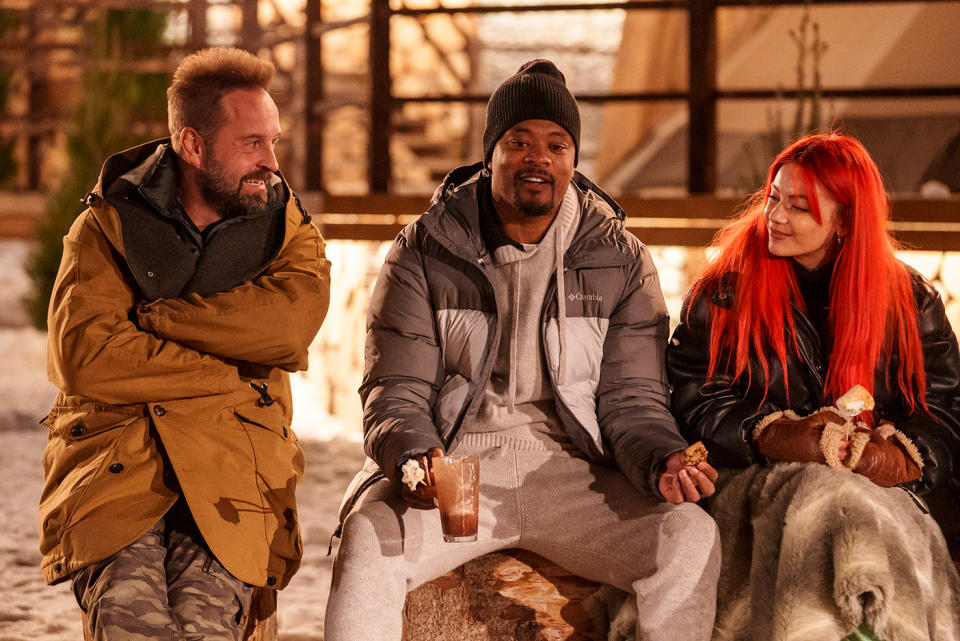 Alfie Boe, Patrice Evra and Dianne Buswell around a campfire