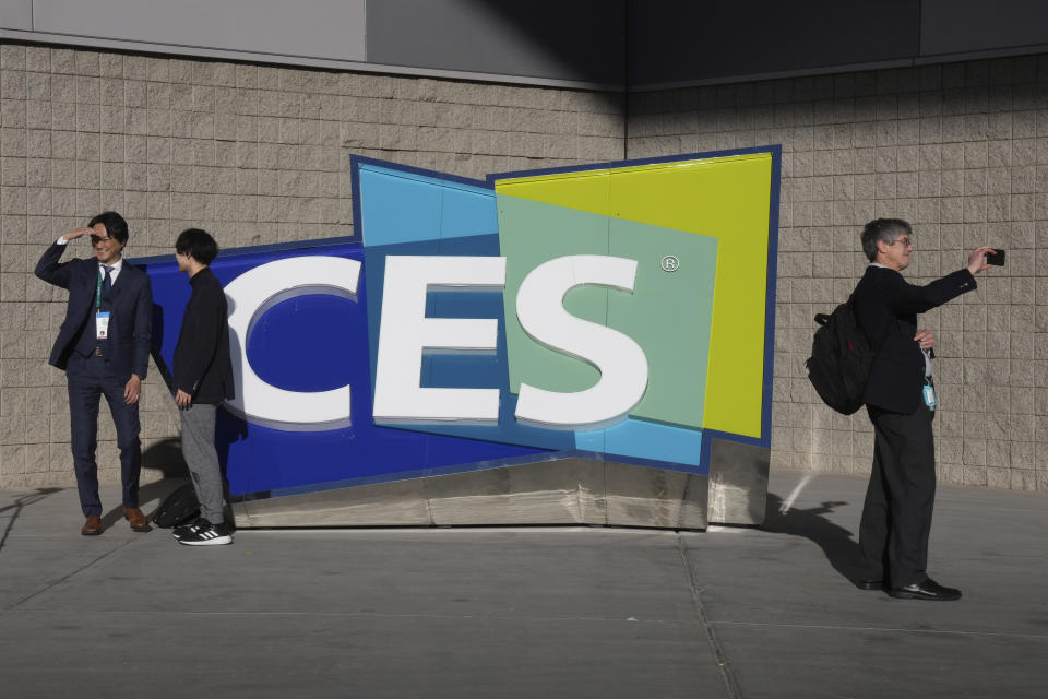 FILE - People take pictures in front of a sign during the CES tech show on Jan. 6, 2022, in Las Vegas. CES is returning to Las Vegas in January 2023 with the hope that it inches closer to how it looked before the pandemic. (AP Photo/Joe Buglewicz, File)