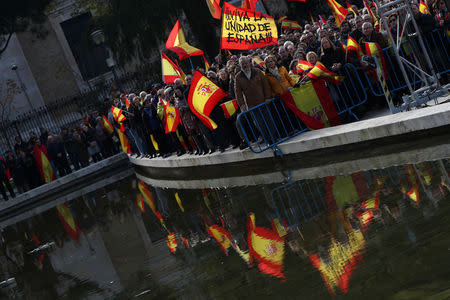 People raise national flags as they call for Spanish unity during a gathering at Colon Square in Madrid, Spain, Decmeber 1, 2018. REUTERS/Sergio Perez