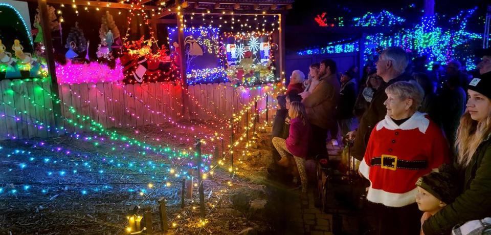 Los Osos resident Judy Hardy, wearing a Santa sweater, and Morro Bay resident Melodie French, right, enjoy the 12 Days of Christmas lighted display at the Cambria Christmas Market on Wednesday, Dec. 14, 2022.