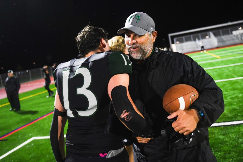 Fossil Ridge head coach Chris Tedford celebrates after winning a high school football game against Windsor at PSD Stadium in Timnath on Thursday. The SaberCats won 35-30.