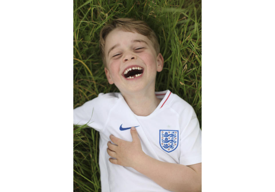 In this undated photo released by the Duke and Duchess of Cambridge on Sunday, July 21, 2019, Britain's Prince George poses for a photo taken by his mother, Kate, the Duchess of Cambridge, in the garden of their home at Kensington Palace, London. Prince George celebrates his sixth birthday on Monday, July 22. (The Duchess of Cambridge via AP)