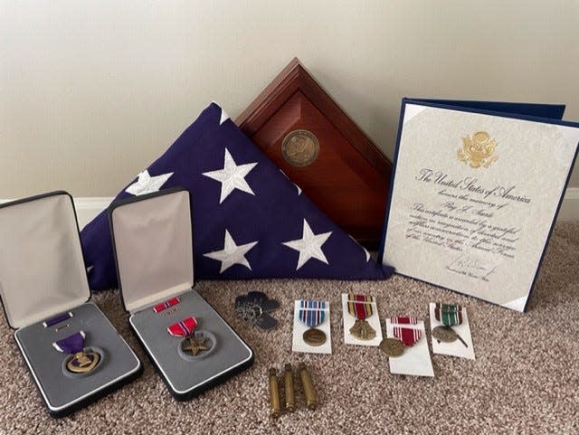PFC Roy J. Searle's cousin Betty Rhodes was presented with his medals from World War II, including a Purple Heart and the Bronze Star.  [Provided by Betty Rhodes]