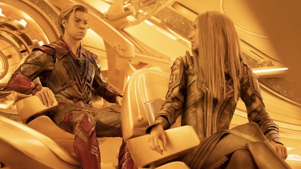 Gold Ayesha turns to speak with gold Adarm Warlock as theyre bathed in gold light in Guardians of the Galaxy Vol. 3