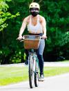 <p>Jennifer Lopez wears a face mask and helmet on a solo bike ride in The Hamptons on Thursday ahead of her 51st birthday. </p>