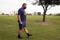 Tevita Uhatafe takes a step as he talks about his job and family, Monday, Sept. 28, 2020, in Grapevine, Texas. Uhatafe was working 60 hours a week before the pandemic struck, hauling baggage and maintaining airplanes as a fleet service clerk for American Airlines at DFW Airport. With the federal funds that helped support the airline industry through the pandemic scheduled to run out, tens of thousands of airline workers like Uhatafe are facing furloughs or layoffs. (AP Photo/LM Otero)