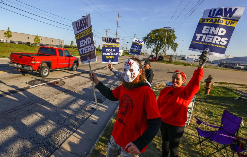 UAW members including Scott Kralovic, wearing a mask, work the picket line during a strike Tuesday, Sept. 19, 2023, at the Stellantis Toledo Assembly Complex where Jeeps are made in Toledo, Ohio.