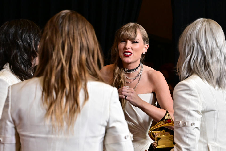 Taylor Swift talks with members of boygenius backstage at the Grammy Awards in Los Angeles.