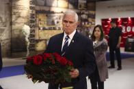 Former U.S. vice president Mike Pence lays a wreath during his visit to the Iranian opposition headquarters in Albania, about 30 kilometers (16 miles) west of Tirana, Albania, Thursday, June 23, 2022. (AP Photo/Franc Zhurda)