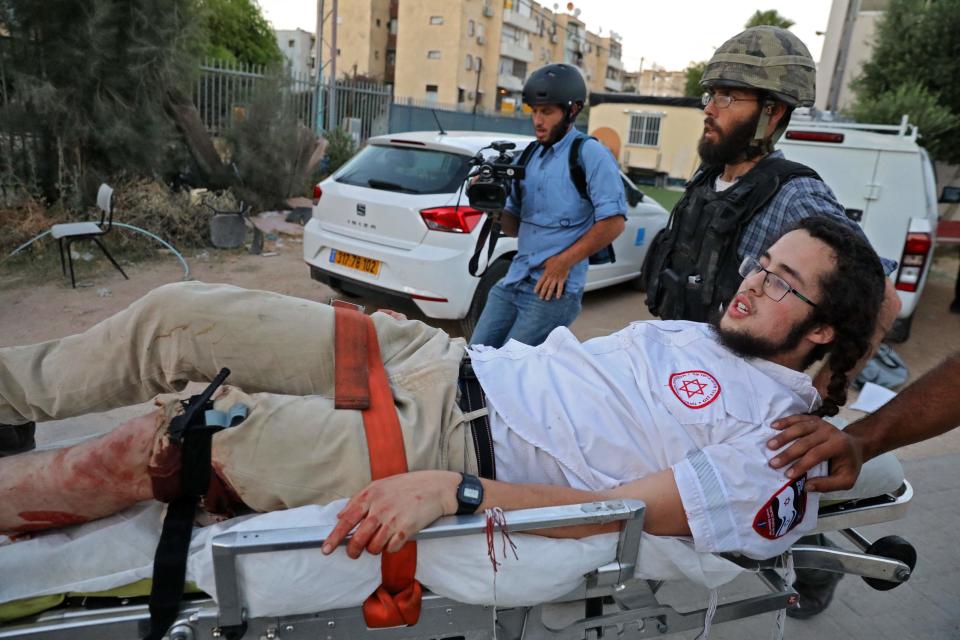 An Israeli far-right extremist is taken away on a stretcher after being wounded during clashes with Arab-Israelis in LodAFP via Getty Images