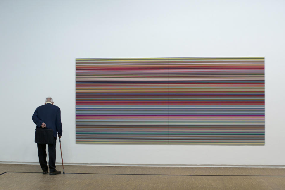 A member of media looks at "Strips" a 2011 painting by German artist Gerhard Richter on the eve of the opening of the exhibition "Gerhard Richter: Panorama", at the Centre Pompidou, Monday, June 4, 2012. (AP Photo/Thibault Camus)