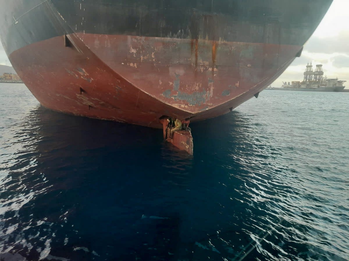 Three stowaway migrants are seen on the rudder blade of petrol vessel Alithini II (via REUTERS)