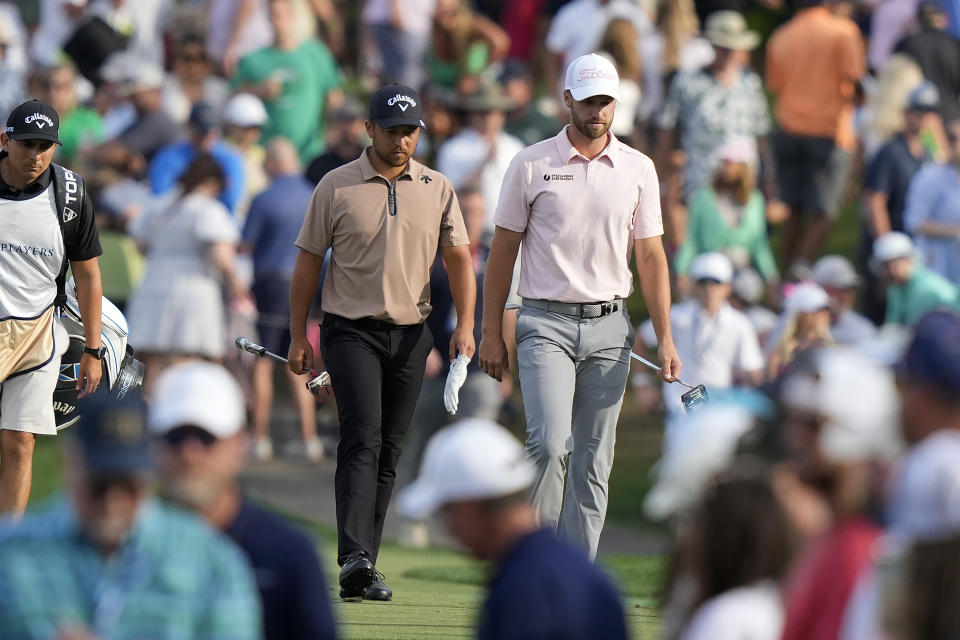 Xander Schauffele, left, and Wyndham Clark walk to the 17th green during the final round of The Players Championship golf tournament Sunday, March 17, 2024, in Ponte Vedra Beach, Fla. (AP Photo/Lynne Sladky)