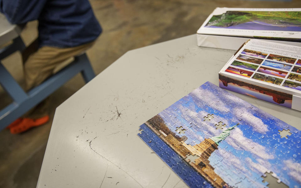 A puzzle of the Statue of Liberty sits on a table in a pod at the Stewart Detention Center, Friday, Nov. 15, 2019, in Lumpkin, Ga. The detention center's remote location compounds the difficulties faced by immigrants trying to fight deportation. (AP Photo/David Goldman)