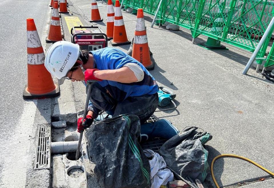 Workers are setting up a black screen to prevent filming.  (Reuters)