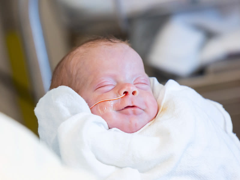 Adalyn Elizabeth Ladner smiles after enjoying a bottle feeding (Courtesy Melanie Thortis / UMMC Photography)