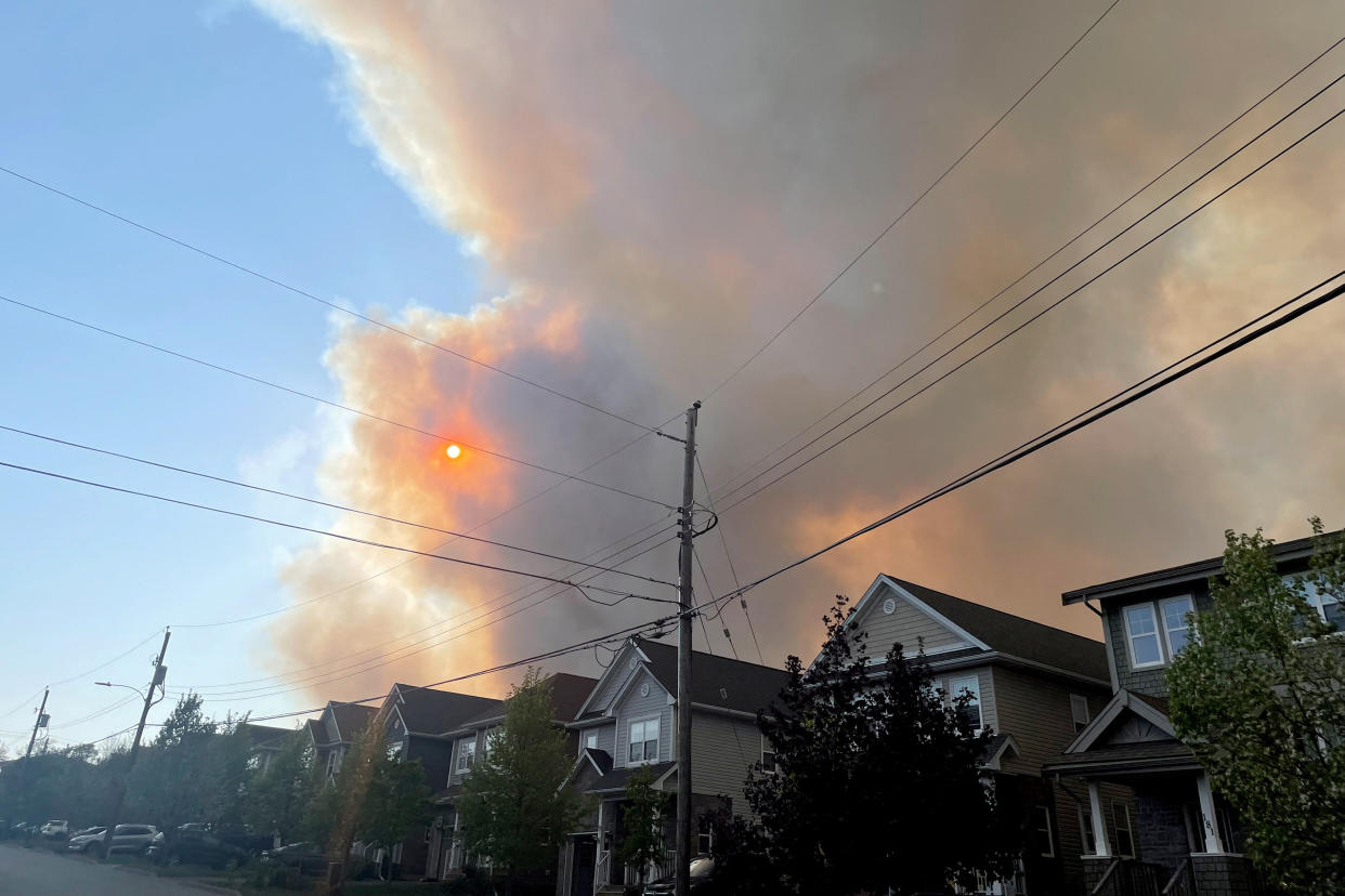 Smoke from the Tantallon wildfire rises over houses in nearby Bedford, Nova Scotia, Canada. (Reuters)