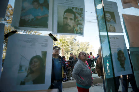 Residents look at pictures of people missing after an explosion of a fuel pipeline ruptured by oil thieves, in the municipality of Tlahuelilpan, state of Hidalgo, Mexico January 21, 2019. REUTERS/Mohammed Salem