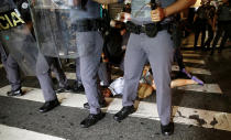 <p>A woman is detained by riot police during a demonstration by supporters of Brazil’s suspended President Dilma Rousseff in Sao Paulo, Brazil, August 30, 2016. (REUTERS/Nacho Doce) </p>