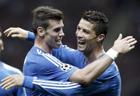 Real Madrid's Cristiano Ronaldo (C) celebrates a goal with team mate Gareth Bale against Galatasaray during their Champions League Group B soccer match at Turk Telekom Arena in Istanbul September 17, 2013. REUTERS/Osman Orsal