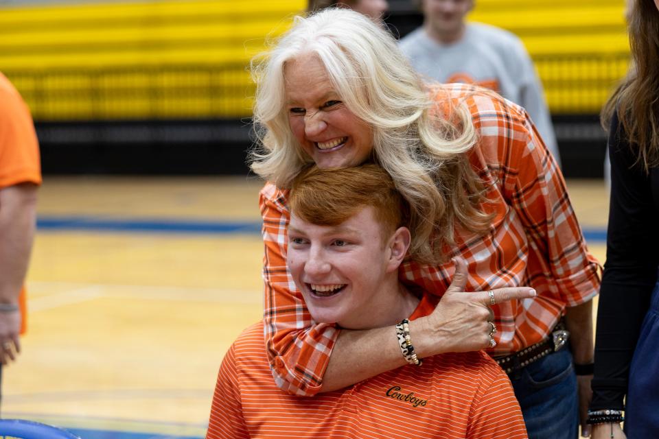 Josh Ford celebrates with his mother, JJ Ford, at a signing day ceremony Monday afternoon at Stillwater High School.
