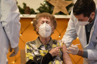 FILE - In this Sunday, Dec. 27, 2020 file photo, a resident of a nursing home gets an injection of the COVID-19 vaccine in Cologne, Germany. Thousands of elderly Germans faced online error messages and jammed up hotlines Monday Jan. 25, 2021, as technical problems marred the start of the coronavirus vaccine campaign for over-80s in the country's most populous state. (AP Photo/Martin Meissner, File)