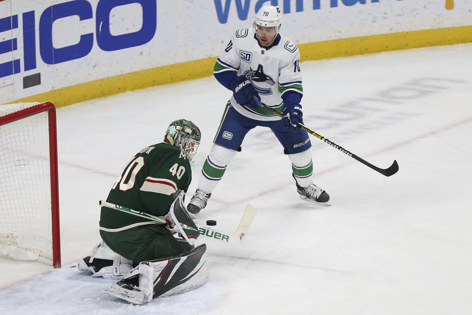 Minnesota Wild's goalie Devan Dubnyk (40) stops the puck in front of the net in the first period of an NHL hockey game against the Vancouver Canucks, Sunday, Jan. 12, 2020, in St. Paul, Minn. (AP Photo/Stacy Bengs)