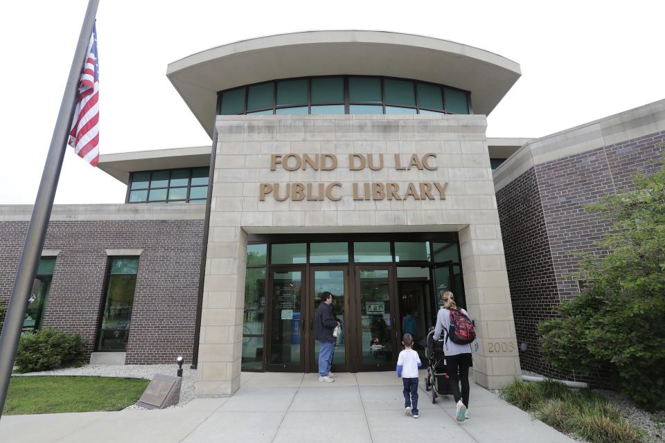 FILE - Community members enter the Fond du Lac Public Library.