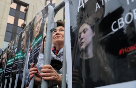 People attend a rally to demand the release of jailed protesters in Moscow
