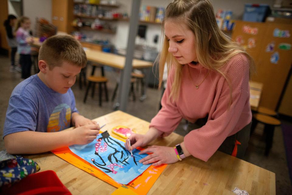 Hollyn Peterson works with students at Meadowbrook Elementary School in Waukesha in March to fulfill her student teaching requirement. Peterson was a double major in art and art education.
