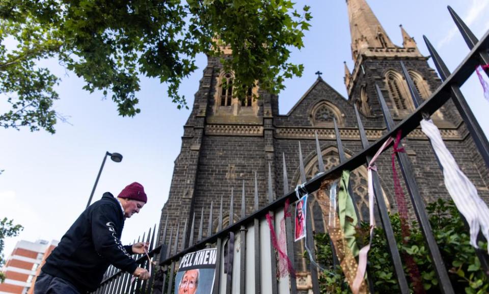 Brian Cherrie tying ribbons to the fence of St Patrick’s Cathedral