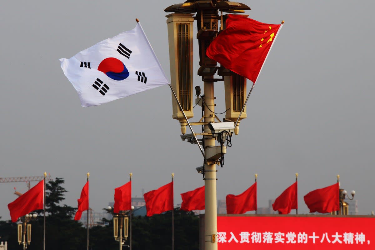 Chinese and South Korean flags flutter in front of Tiananmen Rostrum in Beijing  (Getty Images)