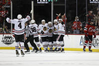 Chicago Blackhawks left wing Dominik Kubalik (8) celebrates with teammates after scoring a goal against the New Jersey Devils during the third period of an NHL hockey game Friday, Oct. 15, 2021, in Newark, N.J. (AP Photo/Adam Hunger)