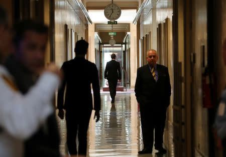 Delegates walk in a corridor during a meeting on forming a constitutional committee in Syria at the United Nations in Geneva, Switzerland, December 18, 2018. REUTERS/Denis Balibouse