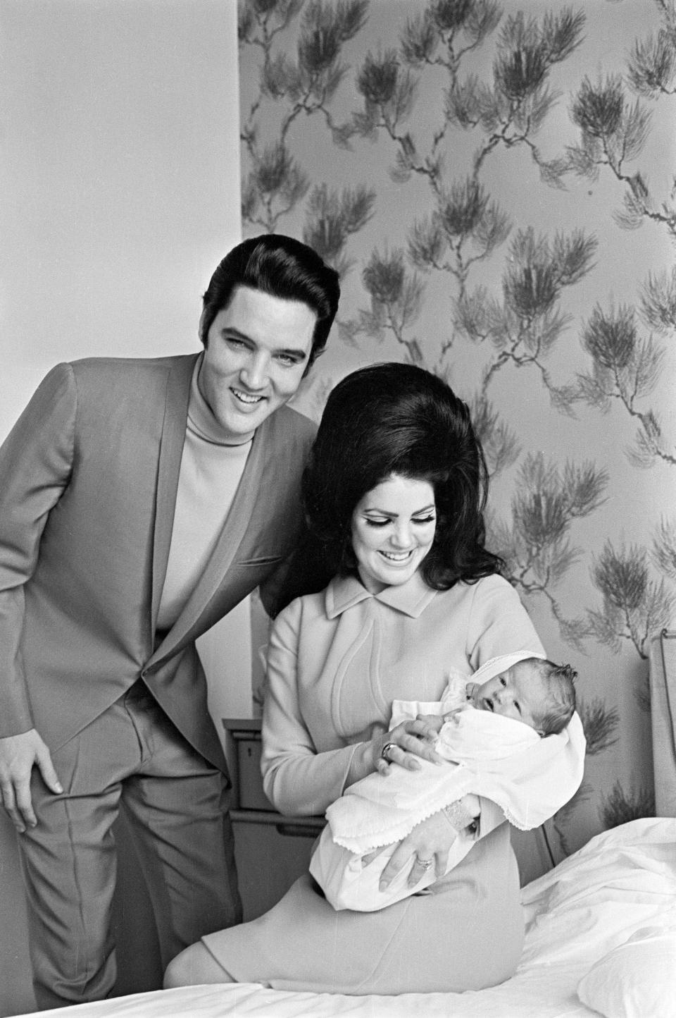 Elvis Presley with Priscilla and their four day old daughter Lisa Marie prepare to leave Baptist Hospital in Memphis, Tennessee.