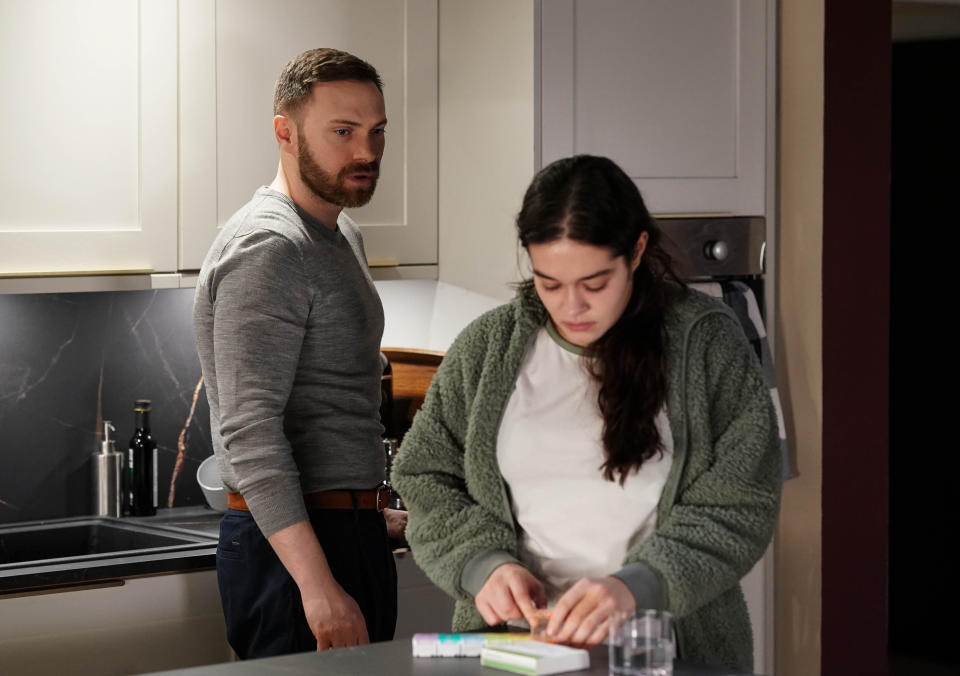 Dean Wicks looking ominously at Jade Green as she  prepares to take her medication