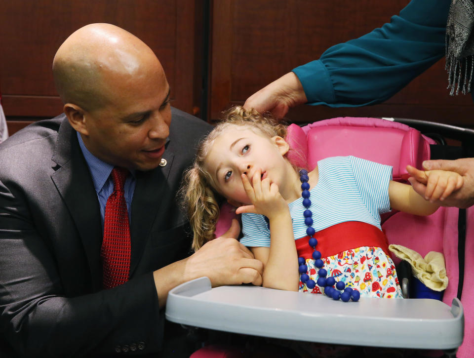Sen. Cory Booker, D-N.J., with 4-year-old Morgan Hintz, who suffers from a rare form of epilepsy, and her mother, who has been advocating the use of cannabinoids for her treatment, during a news conference on Capitol Hill in 2015 to announce a new medical marijuana bill before the U.S. Senate. (Photo: Mark Wilson/Getty Images)