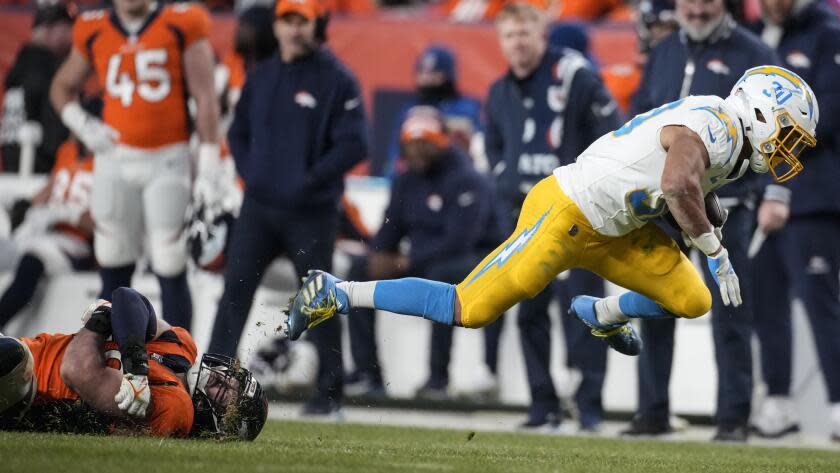 The Chargers' Austin Ekeler (30) runs near the sideline against the Broncos.